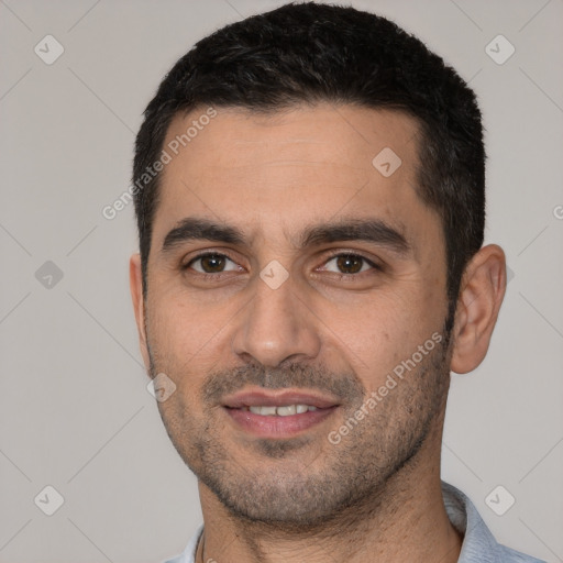 Joyful white young-adult male with short  black hair and brown eyes