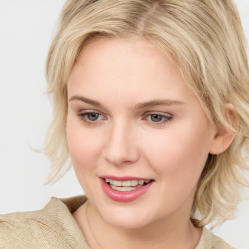 Joyful white young-adult female with medium  blond hair and blue eyes