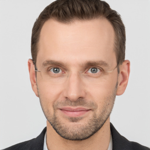 Joyful white adult male with short  brown hair and grey eyes