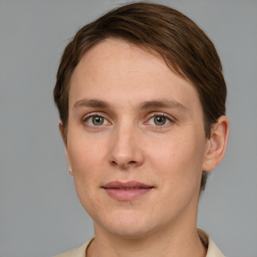 Joyful white young-adult female with short  brown hair and grey eyes