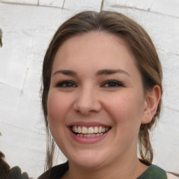 Joyful white young-adult female with medium  brown hair and green eyes