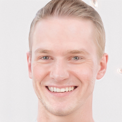 Joyful white young-adult male with short  brown hair and blue eyes