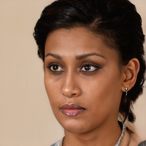Neutral black young-adult female with medium  brown hair and brown eyes