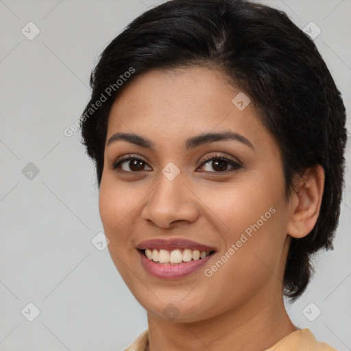 Joyful latino young-adult female with medium  brown hair and brown eyes