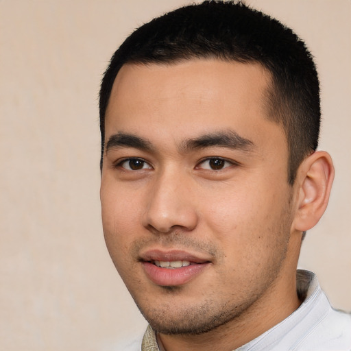 Joyful asian young-adult male with short  black hair and brown eyes