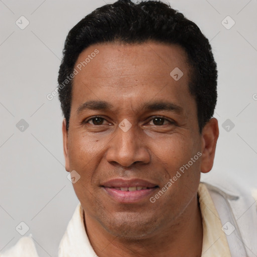 Joyful latino adult male with short  black hair and brown eyes