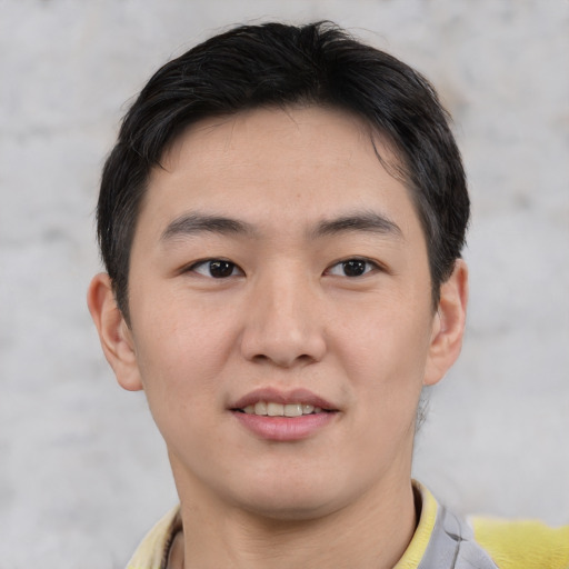 Joyful asian young-adult male with short  brown hair and brown eyes