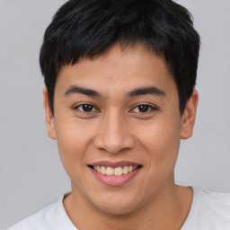 Joyful asian young-adult male with short  black hair and brown eyes