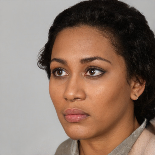 Neutral latino young-adult female with short  black hair and brown eyes