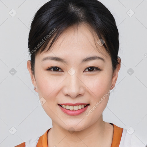 Joyful asian young-adult female with short  brown hair and brown eyes