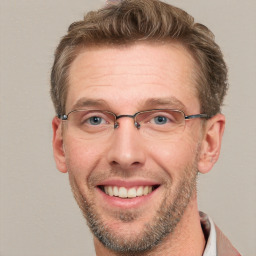 Joyful white adult male with short  brown hair and grey eyes