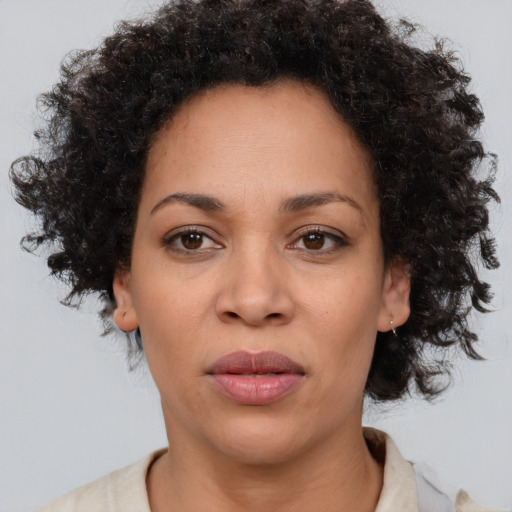Joyful black adult female with medium  brown hair and brown eyes