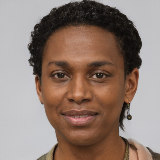 Joyful black young-adult female with short  black hair and brown eyes