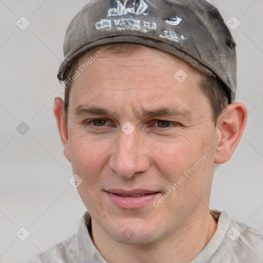 Joyful white adult male with short  brown hair and grey eyes