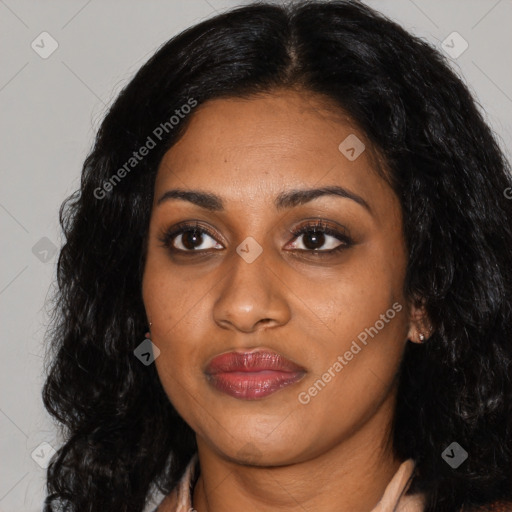 Joyful black young-adult female with long  black hair and brown eyes