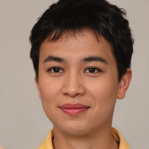 Joyful asian young-adult male with short  brown hair and brown eyes
