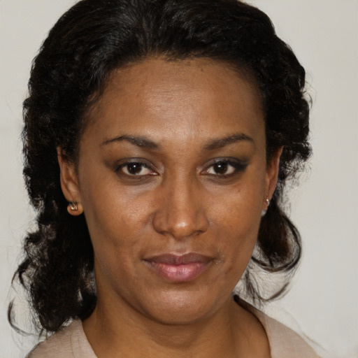Joyful black adult female with medium  brown hair and brown eyes