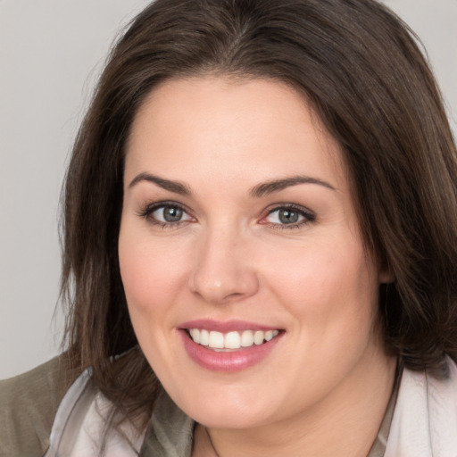 Joyful white young-adult female with medium  brown hair and brown eyes