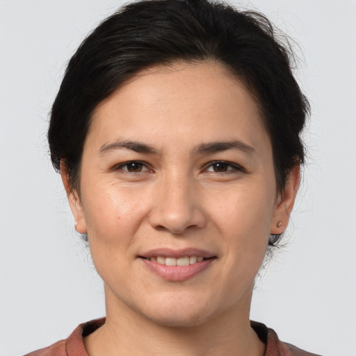 Joyful white young-adult female with medium  brown hair and brown eyes