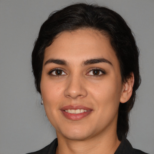 Joyful latino young-adult female with medium  black hair and brown eyes