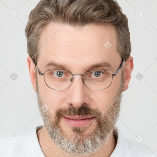 Joyful white adult male with short  brown hair and grey eyes