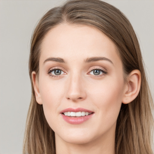 Joyful white young-adult female with long  brown hair and grey eyes