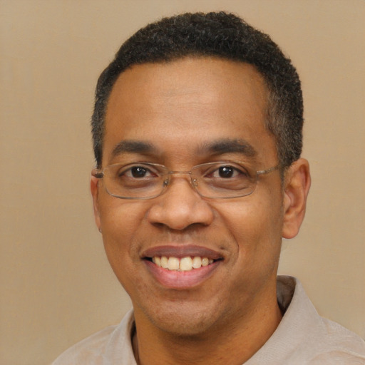 Joyful black adult male with short  black hair and brown eyes