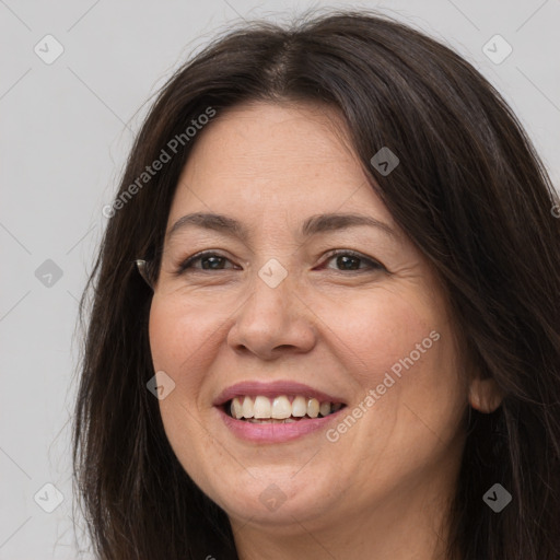 Joyful white adult female with long  brown hair and brown eyes