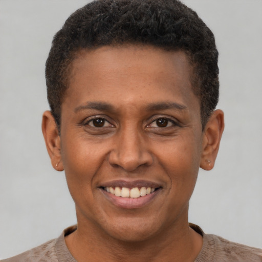 Joyful black young-adult male with short  brown hair and brown eyes