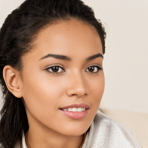 Joyful latino young-adult female with long  brown hair and brown eyes