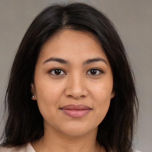 Joyful latino young-adult female with medium  brown hair and brown eyes