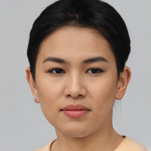 Joyful asian young-adult female with short  black hair and brown eyes