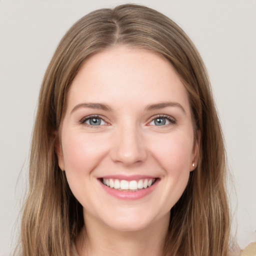 Joyful white young-adult female with long  brown hair and grey eyes