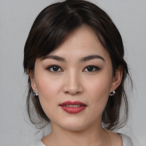 Joyful asian young-adult female with medium  brown hair and brown eyes