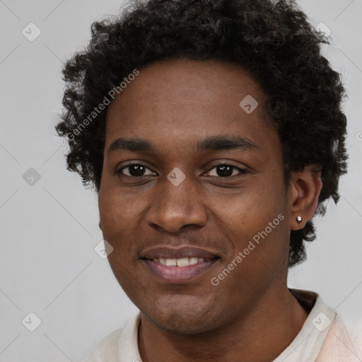 Joyful black young-adult male with short  brown hair and brown eyes