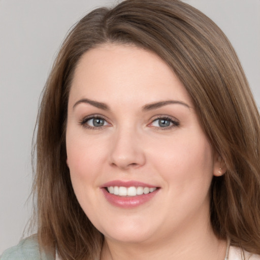 Joyful white young-adult female with medium  brown hair and grey eyes