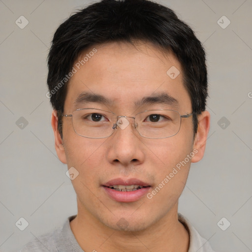 Joyful asian young-adult male with short  brown hair and brown eyes