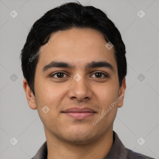 Joyful latino young-adult male with short  brown hair and brown eyes