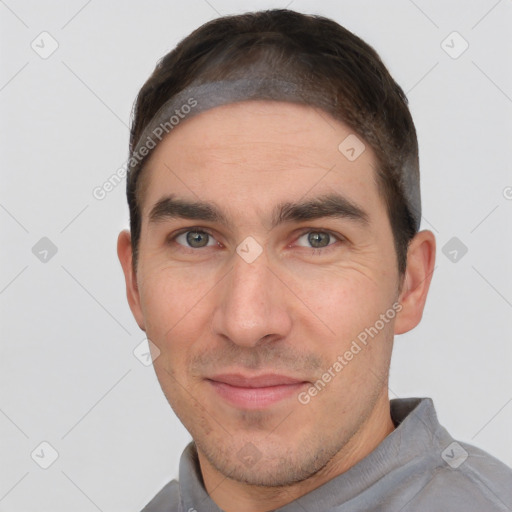 Joyful white adult male with short  brown hair and brown eyes