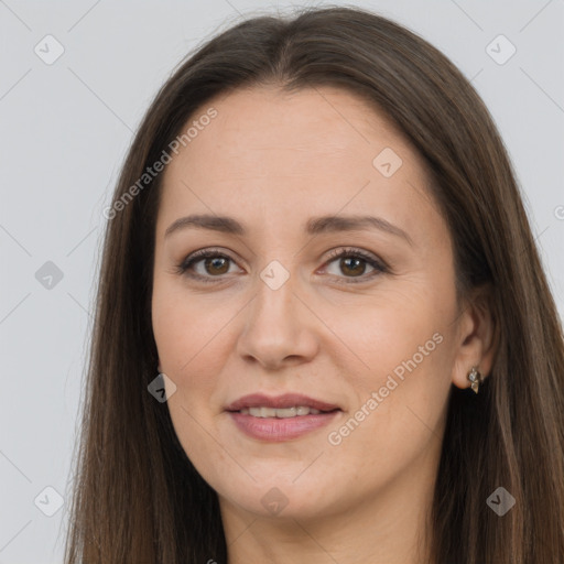 Joyful white adult female with long  brown hair and brown eyes