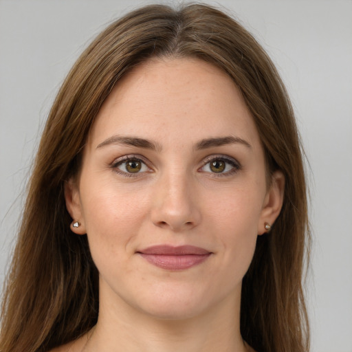 Joyful white young-adult female with long  brown hair and green eyes