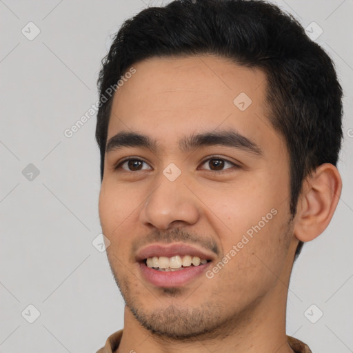 Joyful latino young-adult male with short  black hair and brown eyes