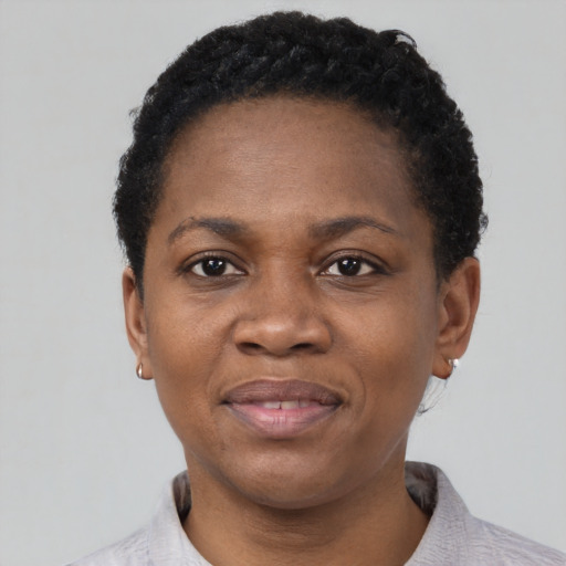 Joyful black adult female with short  black hair and brown eyes