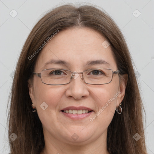 Joyful white adult female with long  brown hair and grey eyes