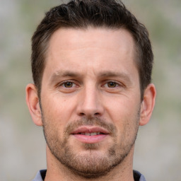 Joyful white adult male with short  brown hair and brown eyes