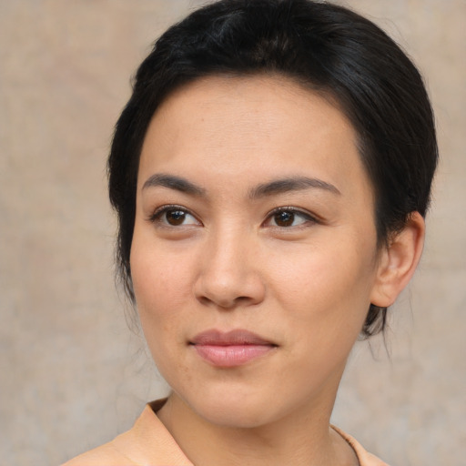 Joyful asian young-adult female with medium  brown hair and brown eyes