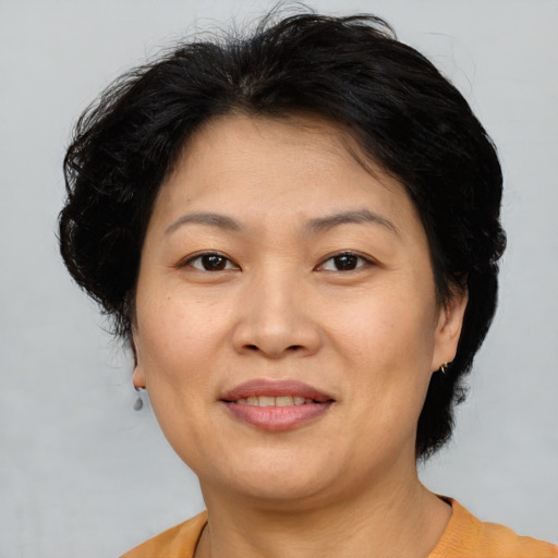 Joyful asian adult female with short  brown hair and brown eyes