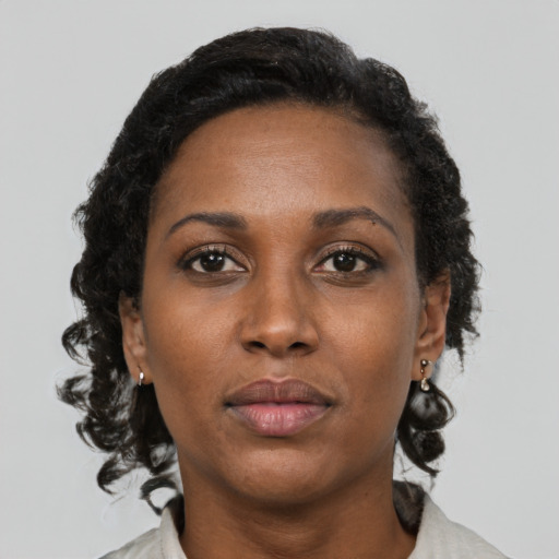 Neutral black adult female with medium  brown hair and brown eyes