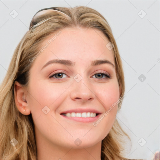 Joyful white young-adult female with long  brown hair and blue eyes