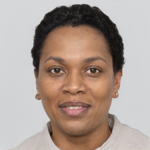 Joyful black adult female with short  black hair and brown eyes